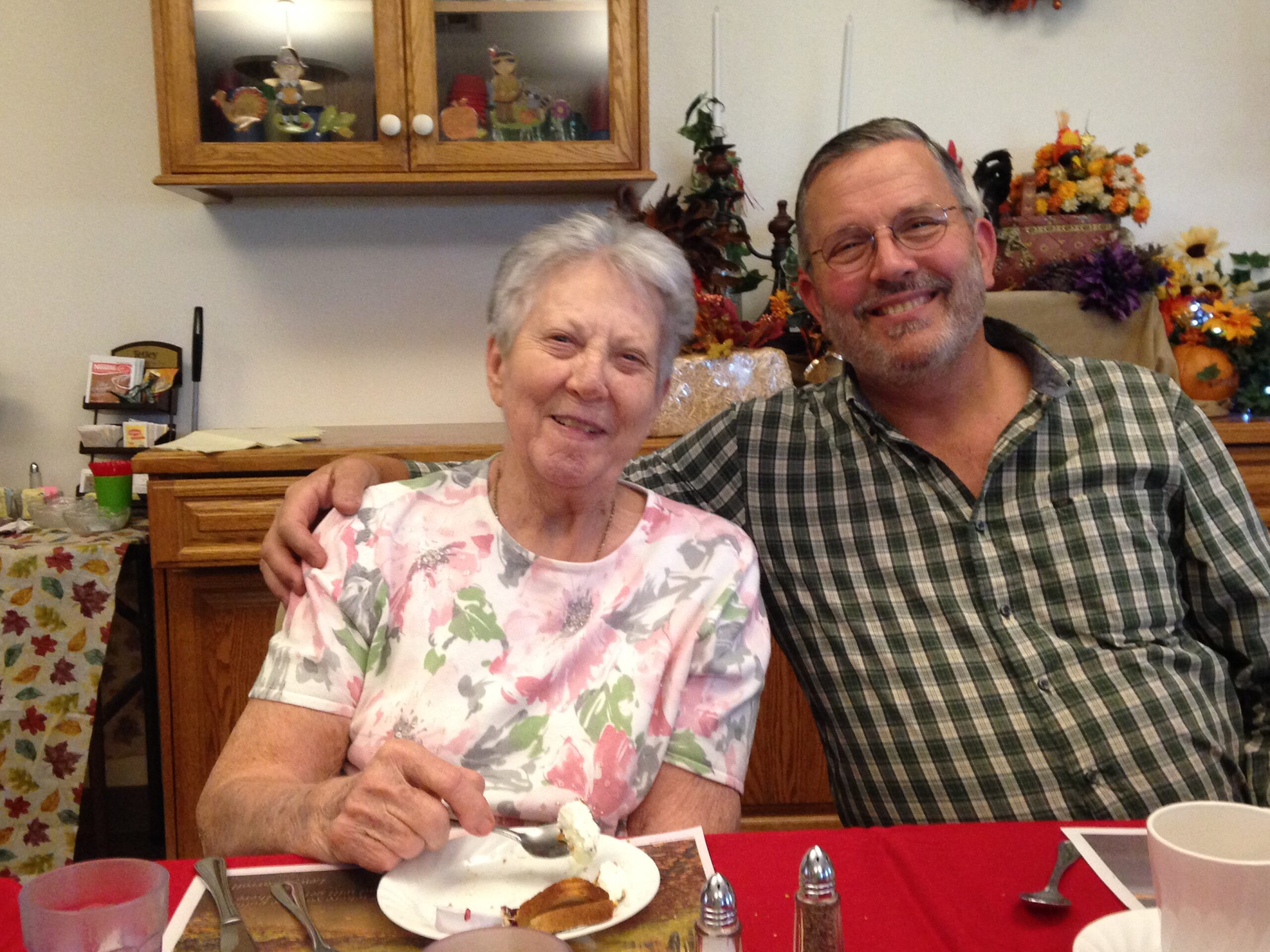 Son with Mom enjoying dinner in assisted living.